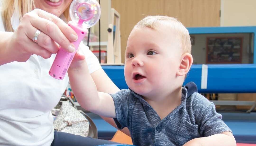 Baby in occupational therapy session reaching