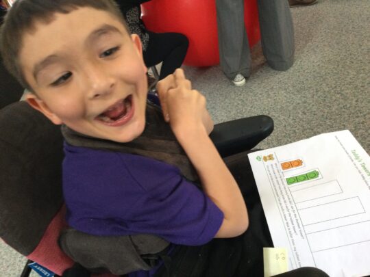 Photo of a boy with a neurodisability in a maths lesson at Pace school