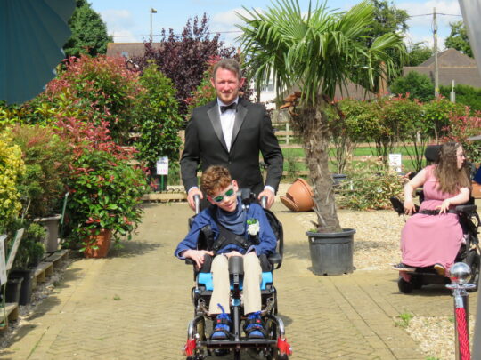 A student going down the red carpet at Pace school prom